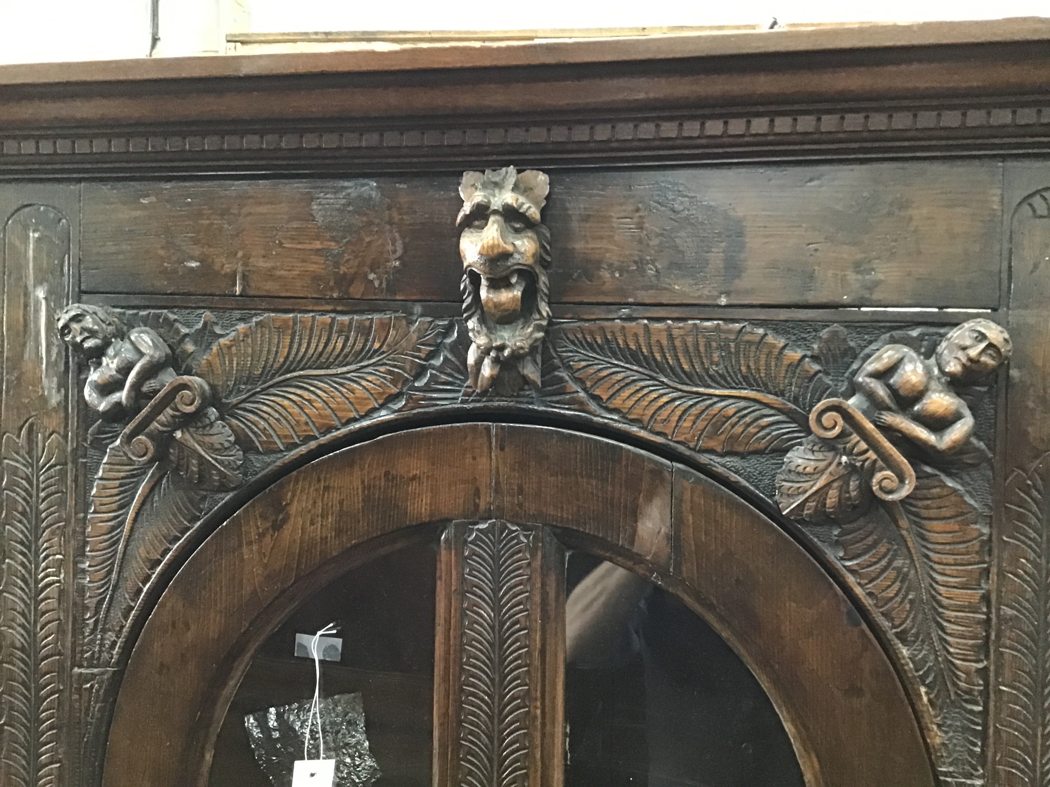 An 18th century style carved oak standing corner cabinet , width 112cm, depth 46cm, height 197cm.